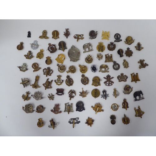 79 - Approx. sixty mainly British, regimental cap badges and associated insignia, some copies: to include... 