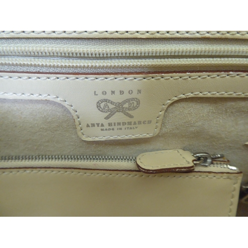 118 - A Gucci holdall and matching handbag in fawn and cream canvas with dust cover; and a Anya Hindmarch ... 