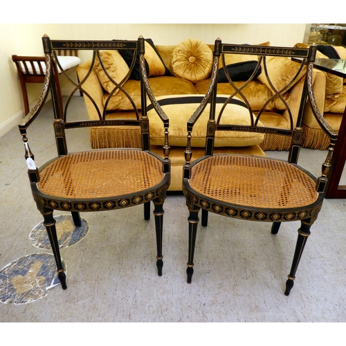 121 - A pair of early 19thC style black painted and gilded beech framed chairs, each having a curved crest... 