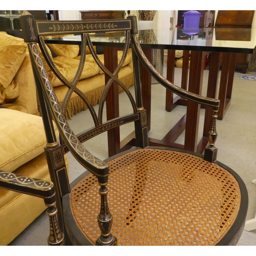 121 - A pair of early 19thC style black painted and gilded beech framed chairs, each having a curved crest... 