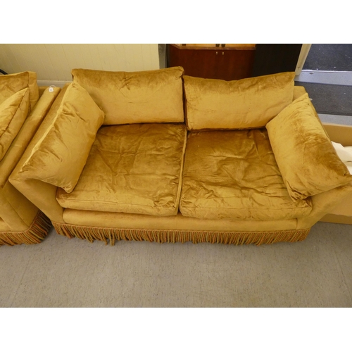 123 - A modern box settee with a low back and enclosed arms, upholstered in tasselled old gold coloured fa... 