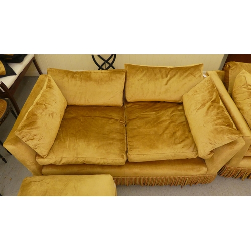 124 - A modern box settee with a low back and enclosed arms, upholstered in tasselled old gold coloured fa... 