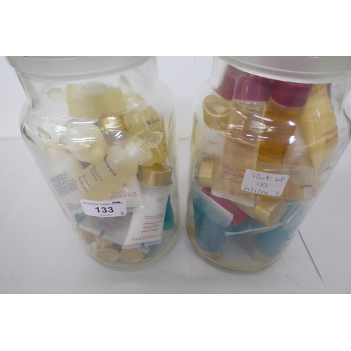 133 - A vast quantity of creams and shampoos samples from Elemis and Champneys, in two covered glass jars