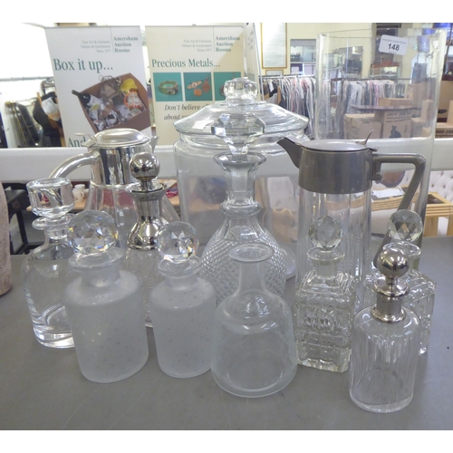 148 - Glass tableware: to include two cordial jugs with applied metal mounts 