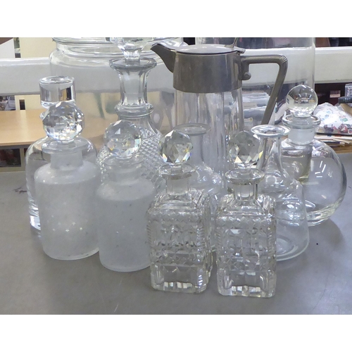 148 - Glass tableware: to include two cordial jugs with applied metal mounts 