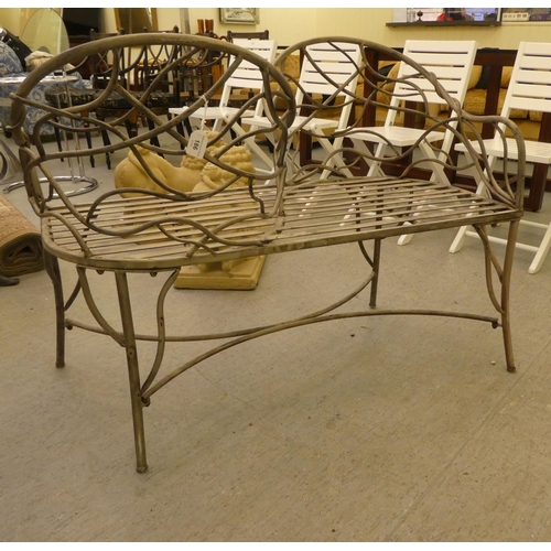 186 - A painted shabby-chic steel wire framed tête-à-tête 'lovers' seat with organically decorated backs