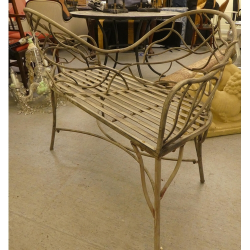 186 - A painted shabby-chic steel wire framed tête-à-tête 'lovers' seat with organically decorated backs