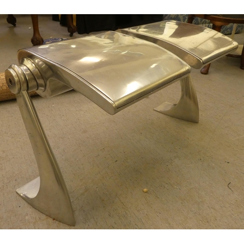 196 - A modern conjoined pair of aluminium and stainless steel stool seats, on canter levered underframes ... 