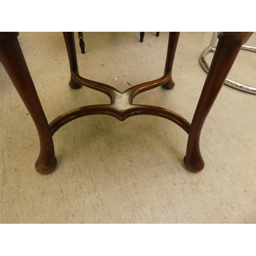 197 - An Edwardian style mahogany and marquetry elbow chair with a solid back and open arms, the upholster... 