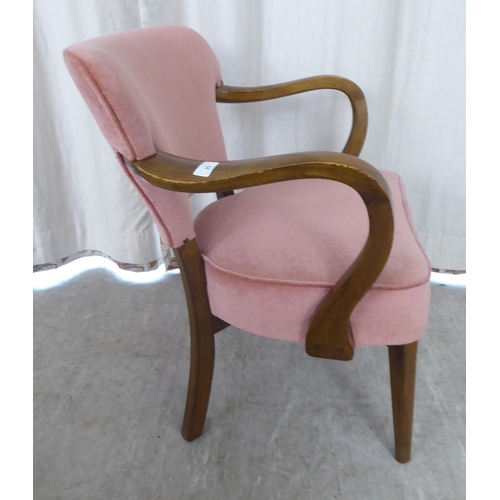 20 - A stained beech framed open arm chair, upholstered in pink fabric, raised on tapered forelegs