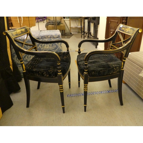 200 - A pair of Regency style black painted and gilt framed elbow chairs with crossover splats and open ar... 