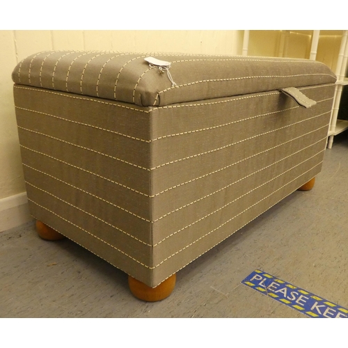 211 - A modern box ottoman, finished in horizontal striped, silver coloured material, the hinged lid enclo... 