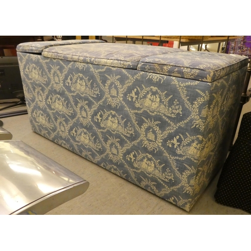 212 - A modern box ottoman, finished in patterned blue and white material with hinged side compartments&nb... 