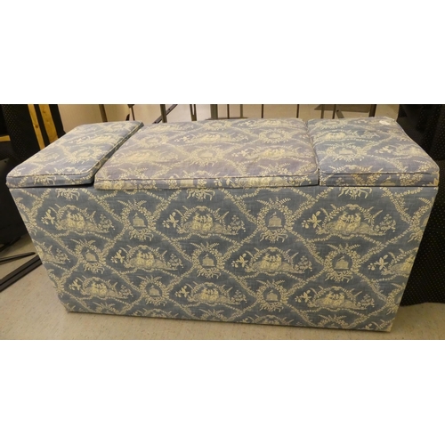 212 - A modern box ottoman, finished in patterned blue and white material with hinged side compartments&nb... 