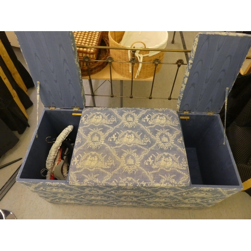 212 - A modern box ottoman, finished in patterned blue and white material with hinged side compartments&nb... 