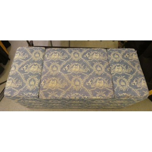 212 - A modern box ottoman, finished in patterned blue and white material with hinged side compartments&nb... 