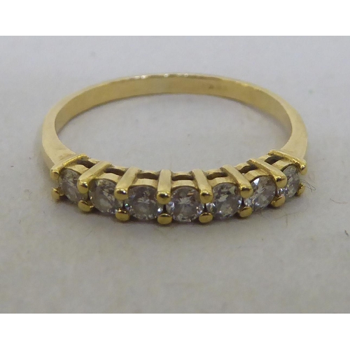 218 - An 18ct gold claw set, seven stone diamond ring 