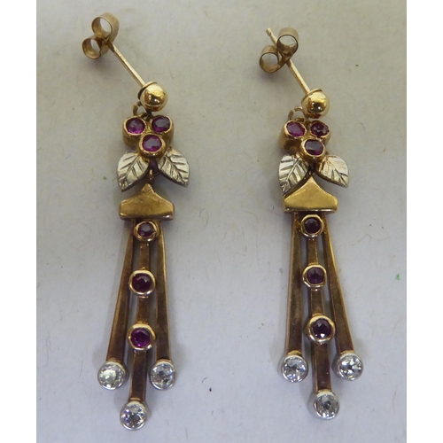 223 - A pair of yellow metal pendant earrings, set with rubies and diamonds 