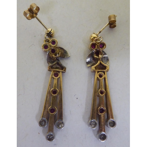 223 - A pair of yellow metal pendant earrings, set with rubies and diamonds 