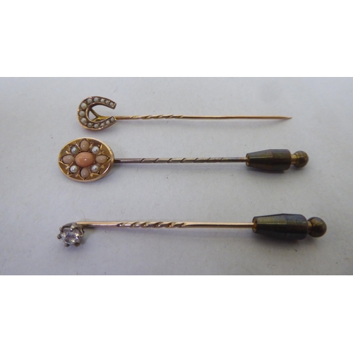 228 - Three dissimilar antique, variously set stick pins 