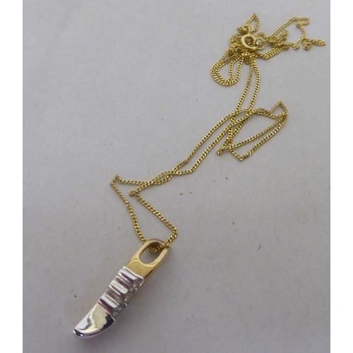 231 - A 9ct bi-coloured gold and three stone diamond set pendant, on a fine neckchain and ring bolt clasp&... 