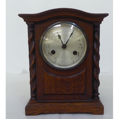 238 - A 1930s oak cased mantel clock; the 8 day movement faced by an Arabic dial  11