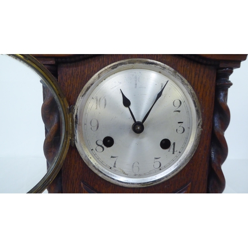 238 - A 1930s oak cased mantel clock; the 8 day movement faced by an Arabic dial  11