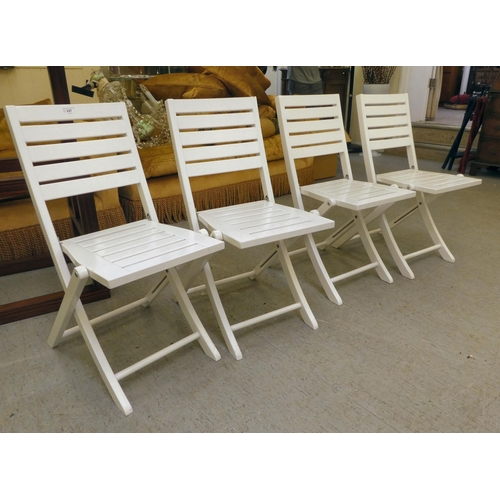 247 - A set of four modern white painted folding patio chairs of slatted construction 