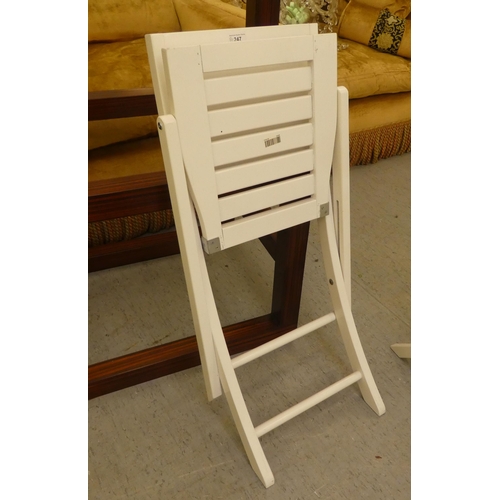 247 - A set of four modern white painted folding patio chairs of slatted construction 