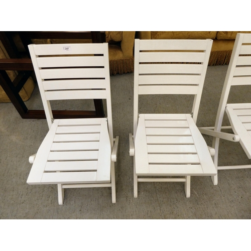 247 - A set of four modern white painted folding patio chairs of slatted construction 