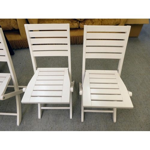 247 - A set of four modern white painted folding patio chairs of slatted construction 