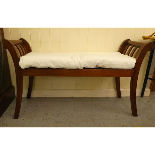 249 - A modern teak window seat with a cream fabric cushion, raised on sabre legs  40