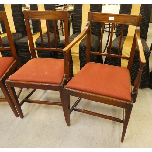 251 - A set of four early 19thC mahogany framed dining chairs, each with a slatted black and drop-in seat,... 