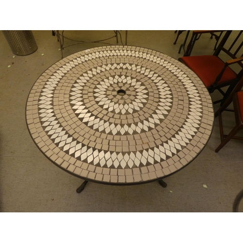 252 - A Kettler composition mosaic top garden table, on a wrought metal base  30