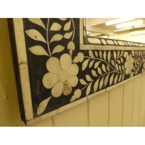 254 - A modern Middle Eastern inspired mirror, decorated in black and white floral designs  41