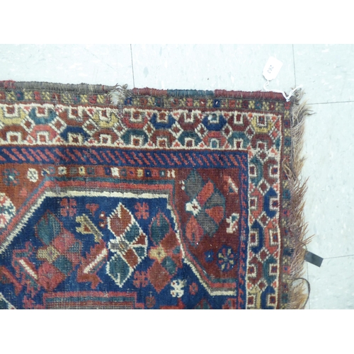 263 - A Persian rug, decorated with triple gul motifs, on a red and blue ground  45