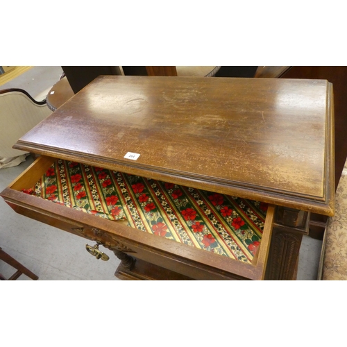 264 - A late 19thC Continental oak cabinet with a drawer and a carved panelled door, raised on turned legs... 