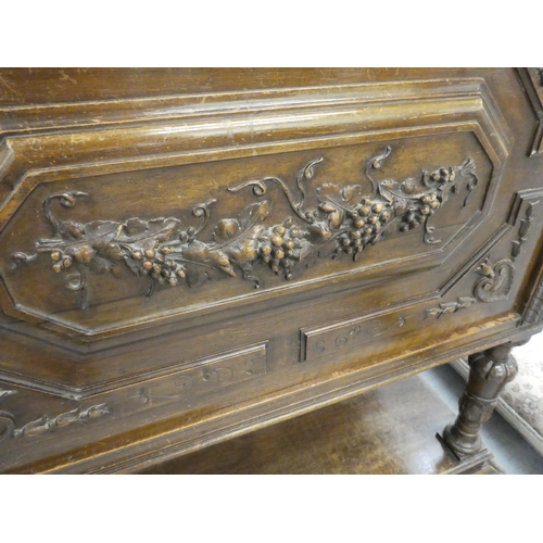 264 - A late 19thC Continental oak cabinet with a drawer and a carved panelled door, raised on turned legs... 