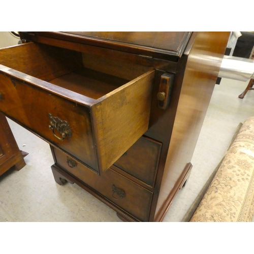 265 - A modern mahogany finished bureau with a fall flap, over three drawers, raised on bracket feet  46