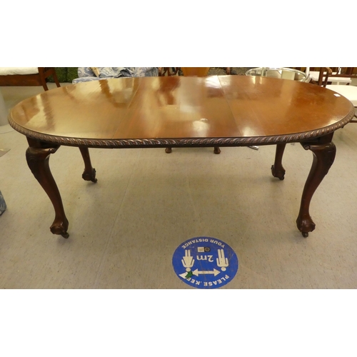 270 - A 1920s mahogany wind-out dining table, raised on cabriole legs, talon and ball feet  30