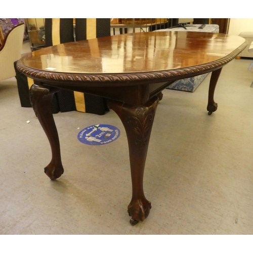 270 - A 1920s mahogany wind-out dining table, raised on cabriole legs, talon and ball feet  30