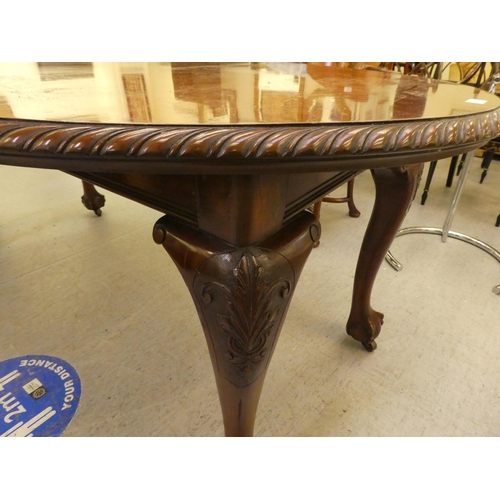 270 - A 1920s mahogany wind-out dining table, raised on cabriole legs, talon and ball feet  30