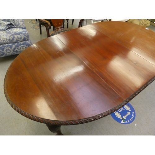 270 - A 1920s mahogany wind-out dining table, raised on cabriole legs, talon and ball feet  30