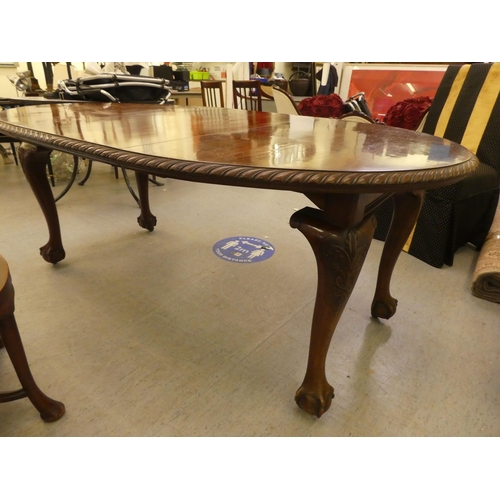 270 - A 1920s mahogany wind-out dining table, raised on cabriole legs, talon and ball feet  30