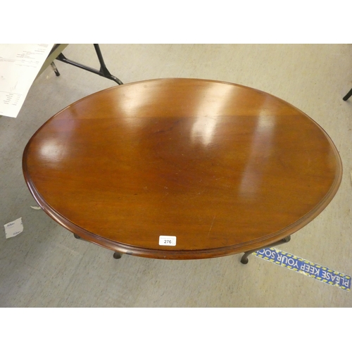 276 - An early 20thC mahogany, oval, two tier occasional table, raised on slender legs and pad feet  ... 