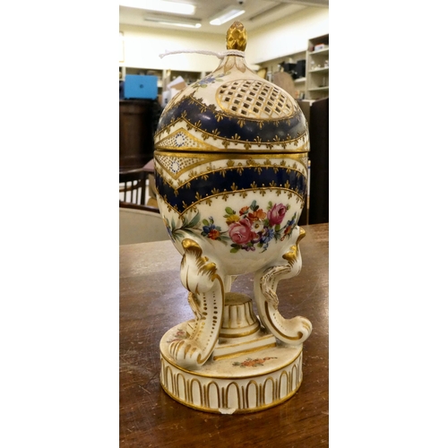 278 - A Dresden porcelain hinged egg cup design trinket box, on a tripod case and circular plinths  6... 