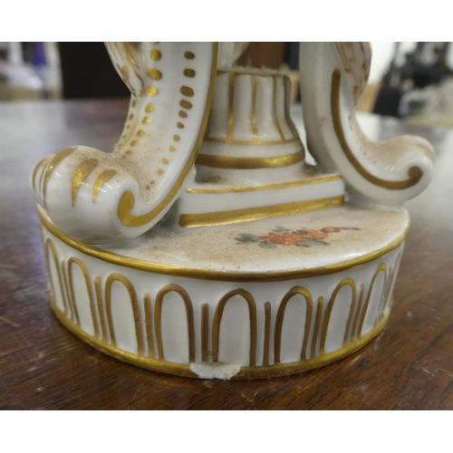 278 - A Dresden porcelain hinged egg cup design trinket box, on a tripod case and circular plinths  6... 