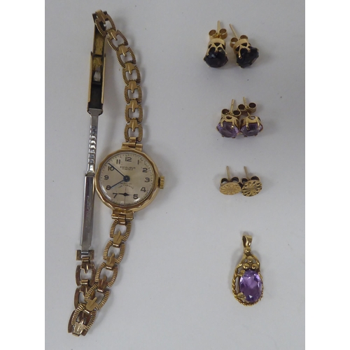 63 - 9ct gold mounted jewellery; and a 9ct gold cased wristwatch, faced by an Arabic dial, on a gold plat... 