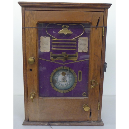 70 - An early 20thC oak and glazed cased coin operated Handan-Ni-Domino table-top game  28