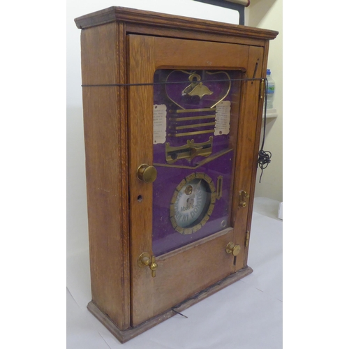 70 - An early 20thC oak and glazed cased coin operated Handan-Ni-Domino table-top game  28